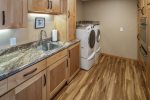 Butler`s pantry off kitchen with high capacity washer & dryer.